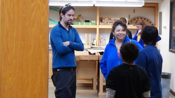 ENGAGE boys and teacher visit with UW graduate student in wood shop