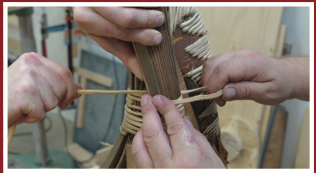 hands at work on canoe