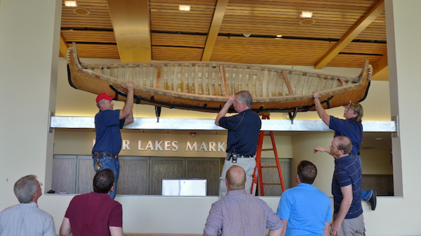 Canoe being lifted into place in Dejope Hall