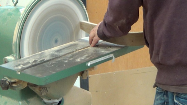 rib being sanded on a circular sander