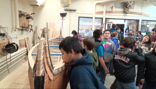 Lac du Flambeau school children view canoe for first time