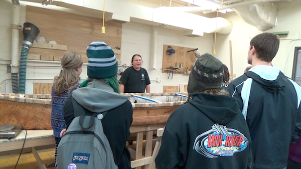 talking with a student group that has come to see the canoe