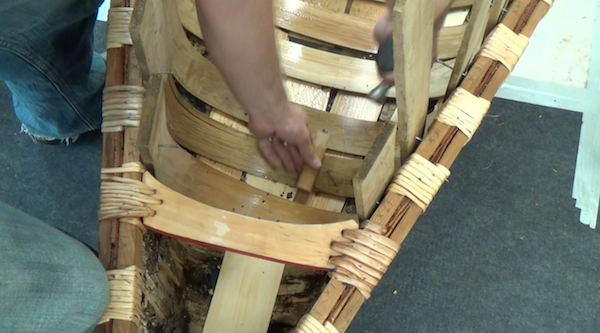 tapping rib into place with sheathing