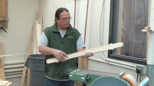 Sanding the center thwart on belt sander