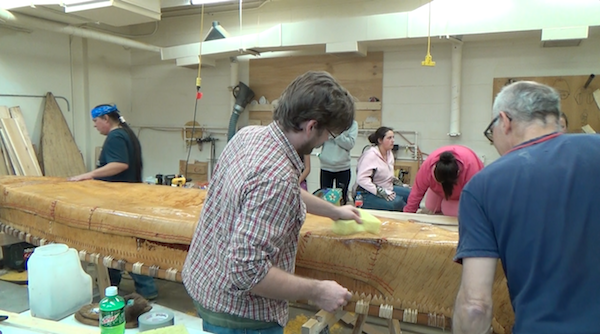 Dowsing the canoe bottom with boiling water